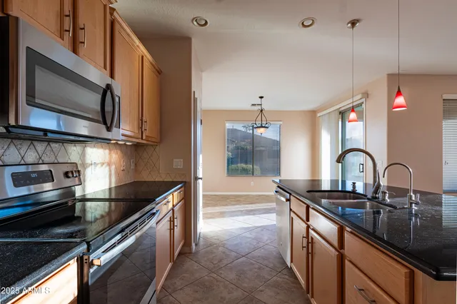 a view of a kitchen and a refrigerator