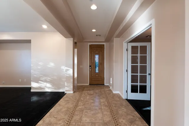 a view of kitchen with kitchen island stainless steel appliances refrigerator oven cabinets and living room view