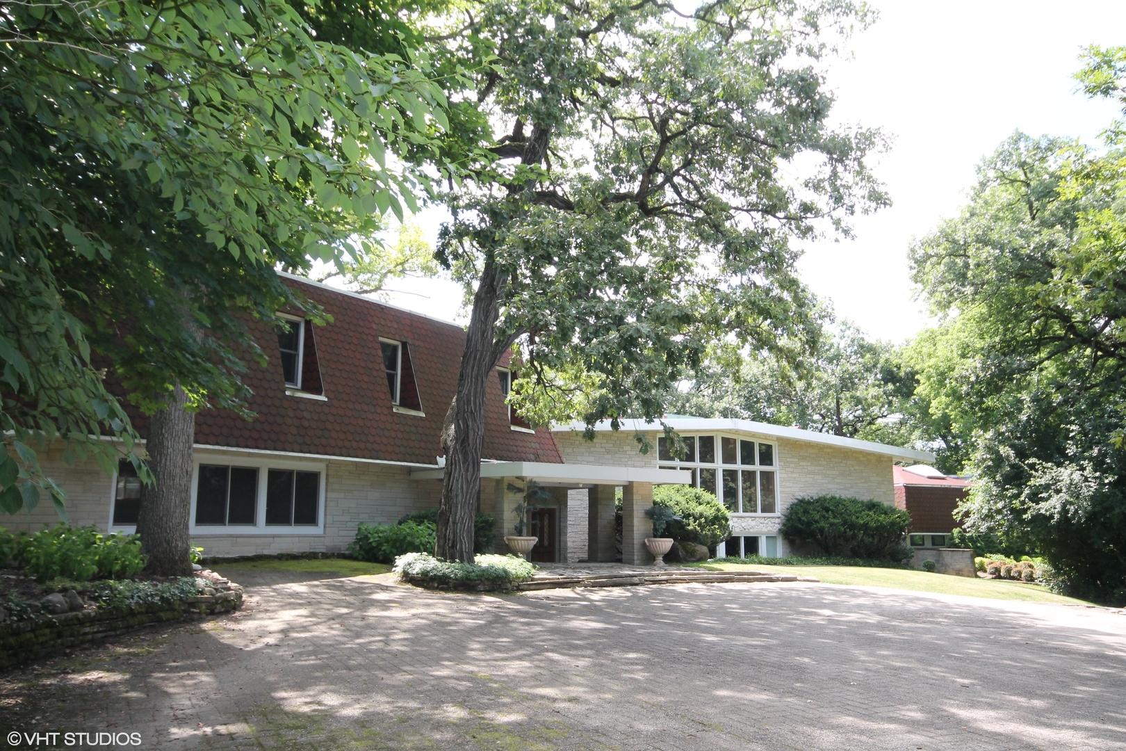 231 West County Line Road Barrington Hills, IL 60010 - Photo 2 of 35 a front view of a house with a patio
