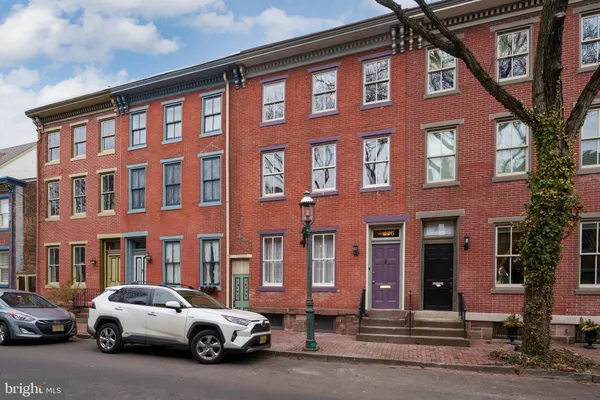 a couple of cars parked in front of brick building