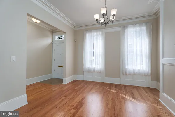a view of wooden floor and windows in an empty room