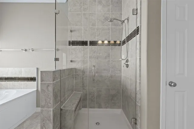 a bathroom with a bathtub and a shower