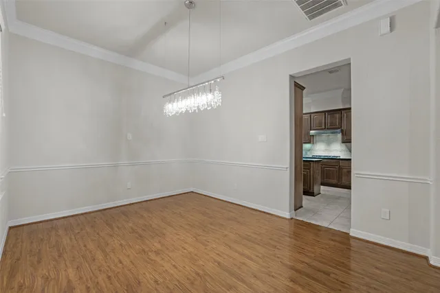 wooden floor in an empty room with a bathroom