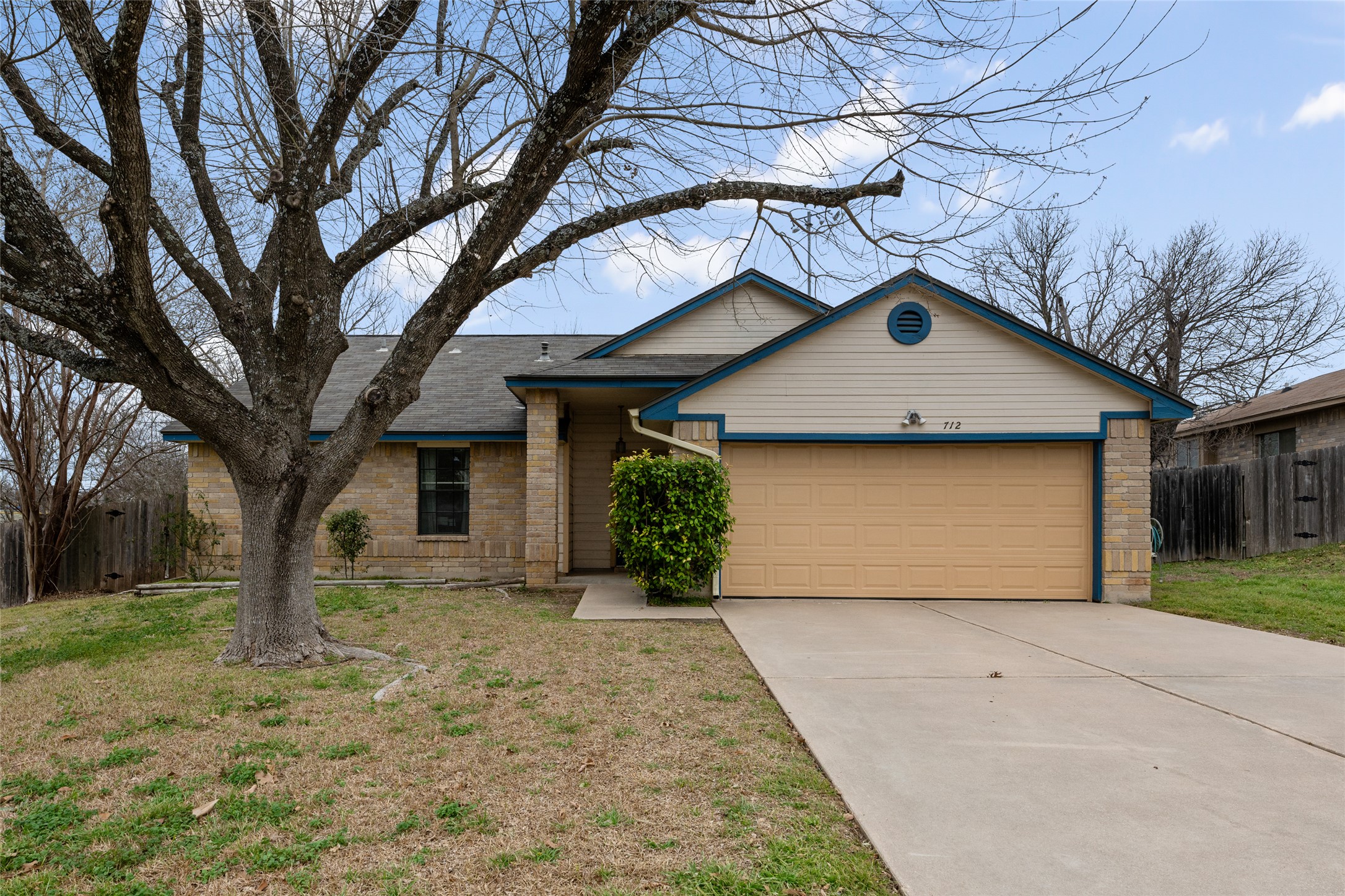712 Quail Run Road Pflugerville, TX 78660 - Photo 1 of 1 Ranch-style house featuring a garage, concrete driveway, fence, and a front lawn.