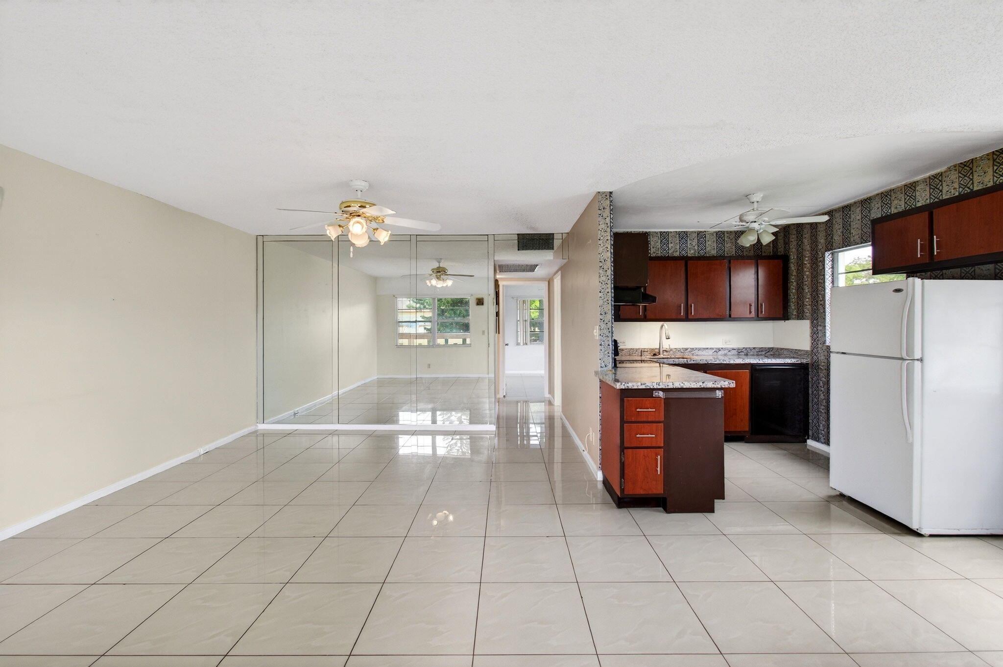 a kitchen with stainless steel appliances a refrigerator and microwave