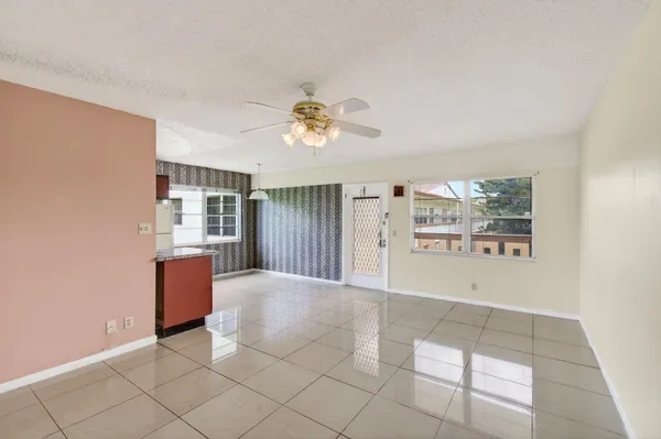 a view of room with window and refrigerator