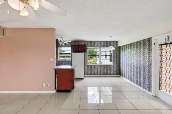 a kitchen with stainless steel appliances granite countertop a refrigerator and a stove