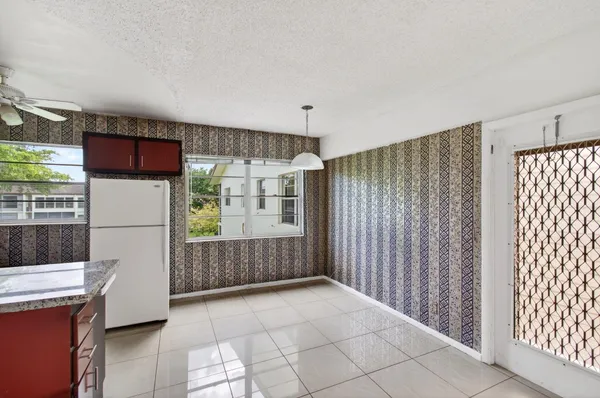 a kitchen with stainless steel appliances a refrigerator and a stove top oven