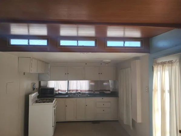 a kitchen with stainless steel appliances granite countertop a sink and a window