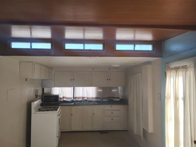 a kitchen with stainless steel appliances granite countertop a sink and a window