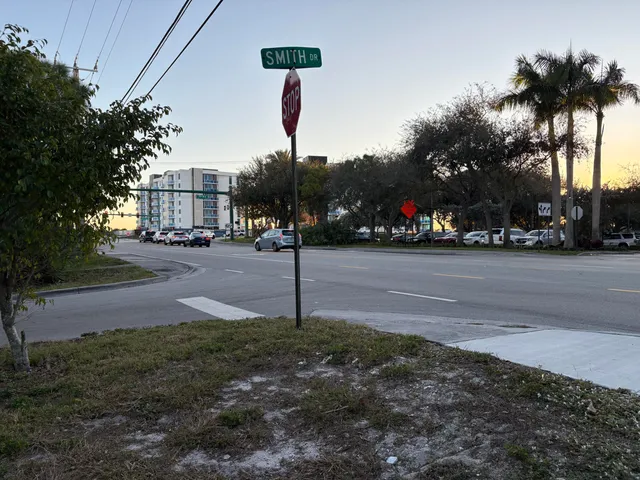 a street sign on a sidewalk next to a road