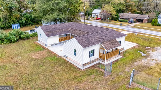 an aerial view of a house with a yard basket ball court and outdoor seating