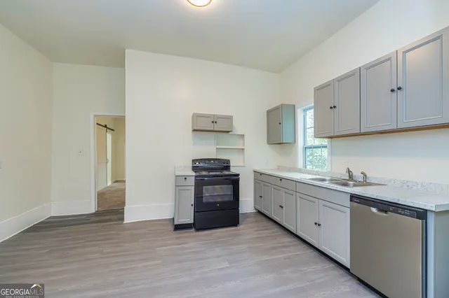 a kitchen with stainless steel appliances granite countertop a stove and a sink