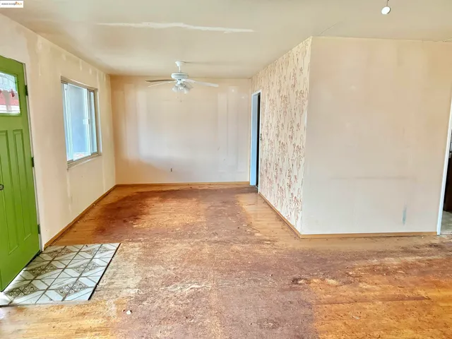 wooden floor in an empty room with a window
