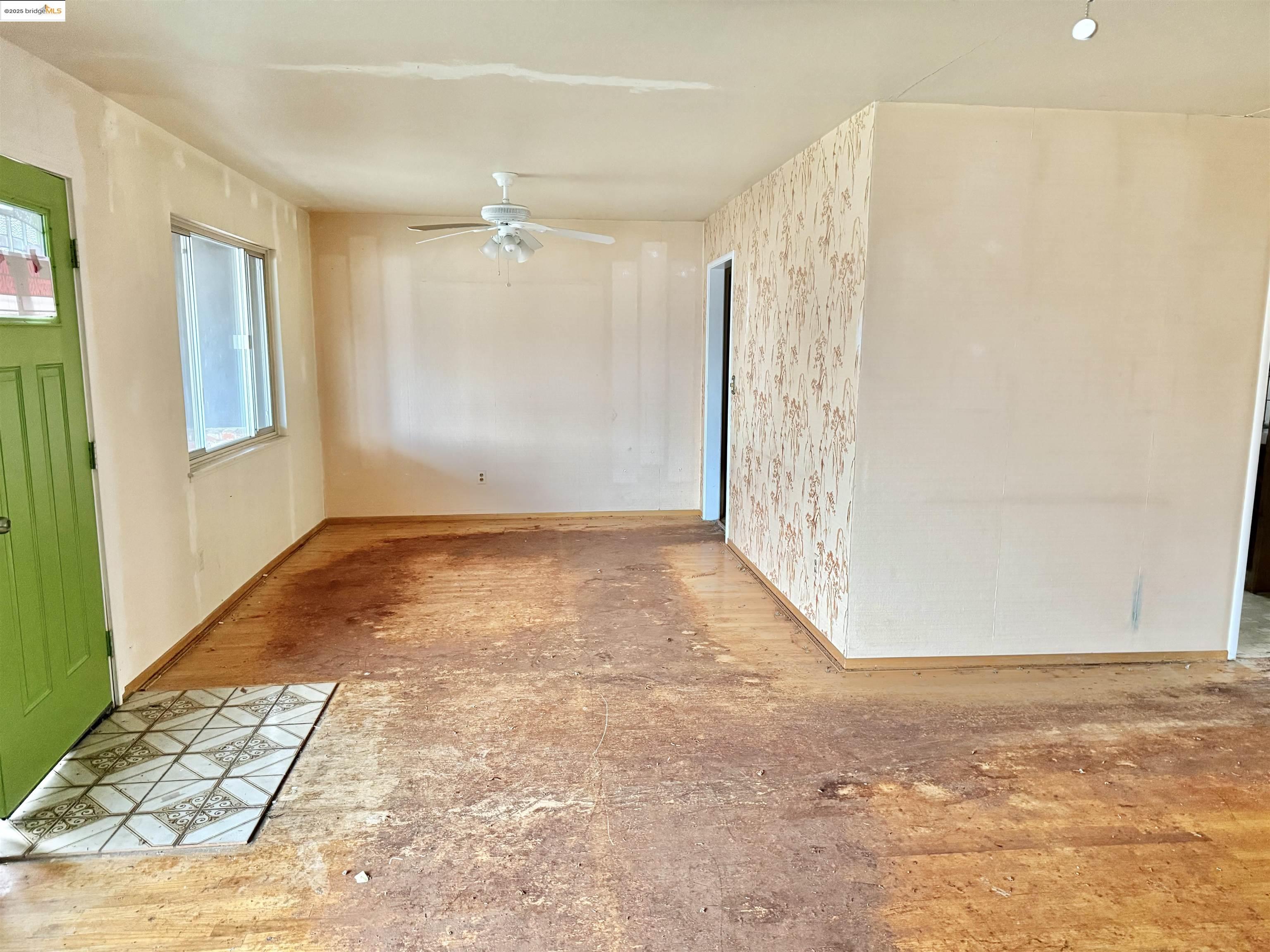 949 Flores Way Rio Vista, CA 94571 - Photo 5 of 19 wooden floor in an empty room with a window