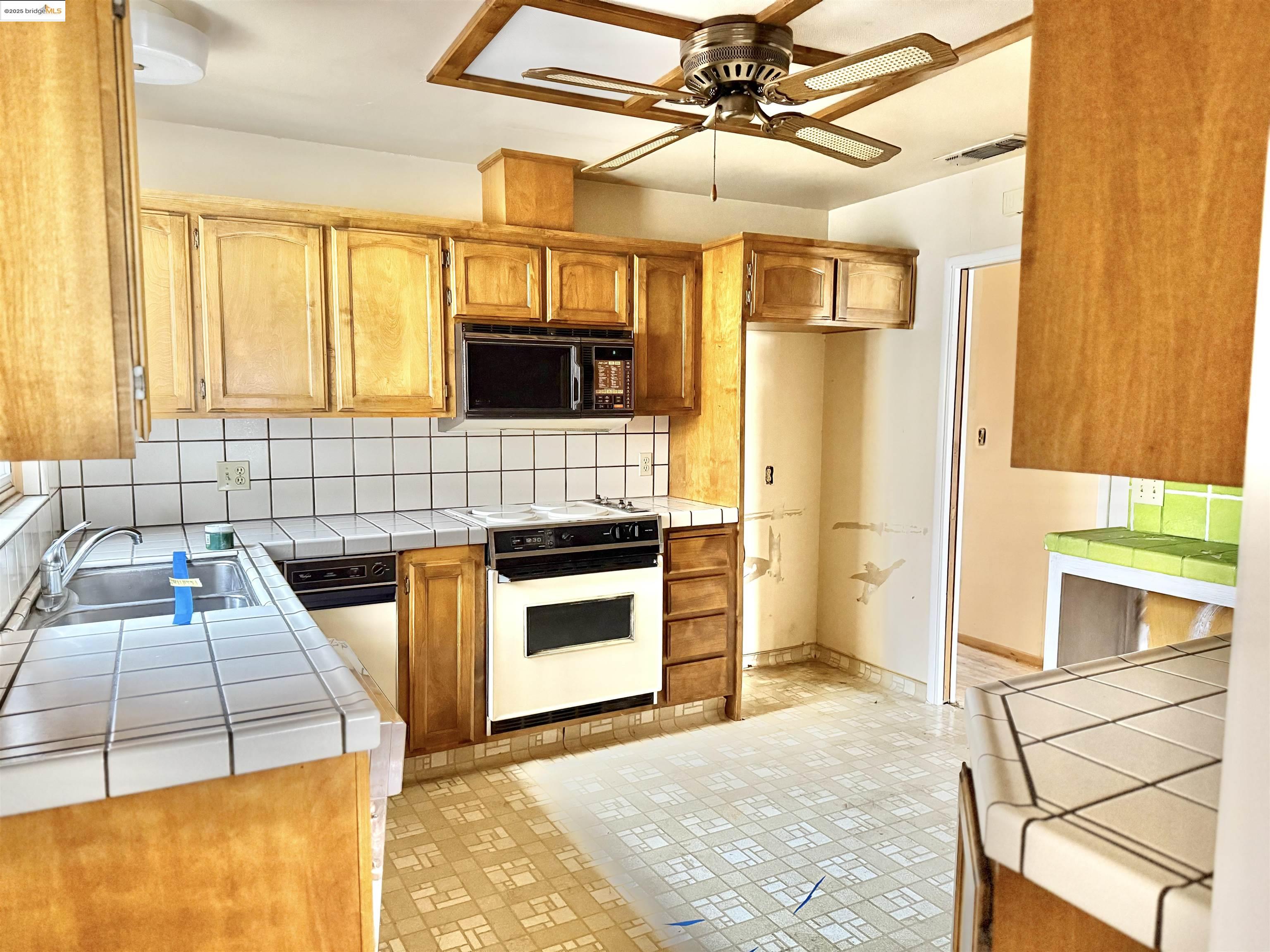 949 Flores Way Rio Vista, CA 94571 - Photo 8 of 19 a kitchen with stainless steel appliances granite countertop a stove and a sink