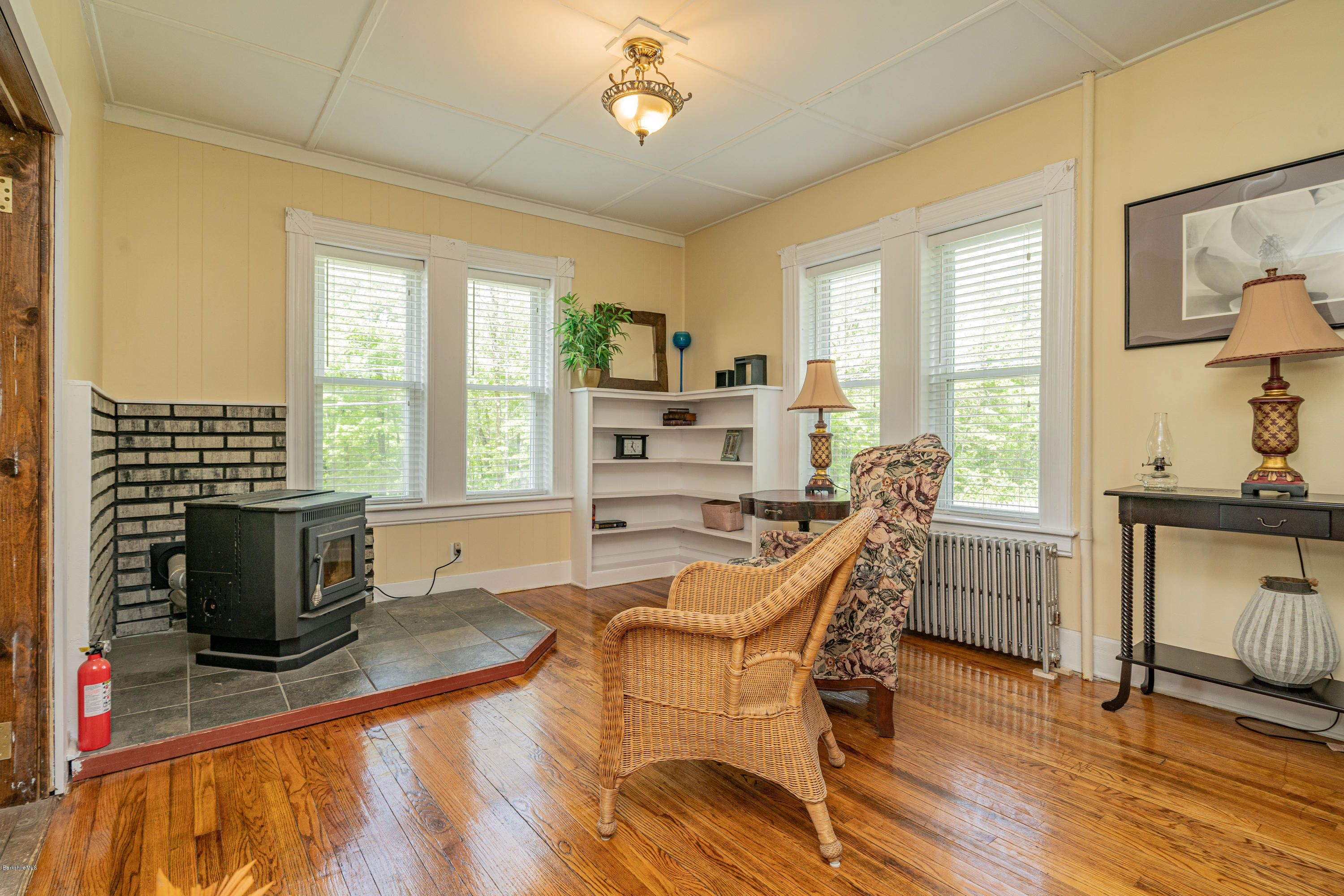 22 Wade Inn Road Becket, MA 01223 - Photo 16 of 32 a living room with furniture a fireplace and a flat screen tv