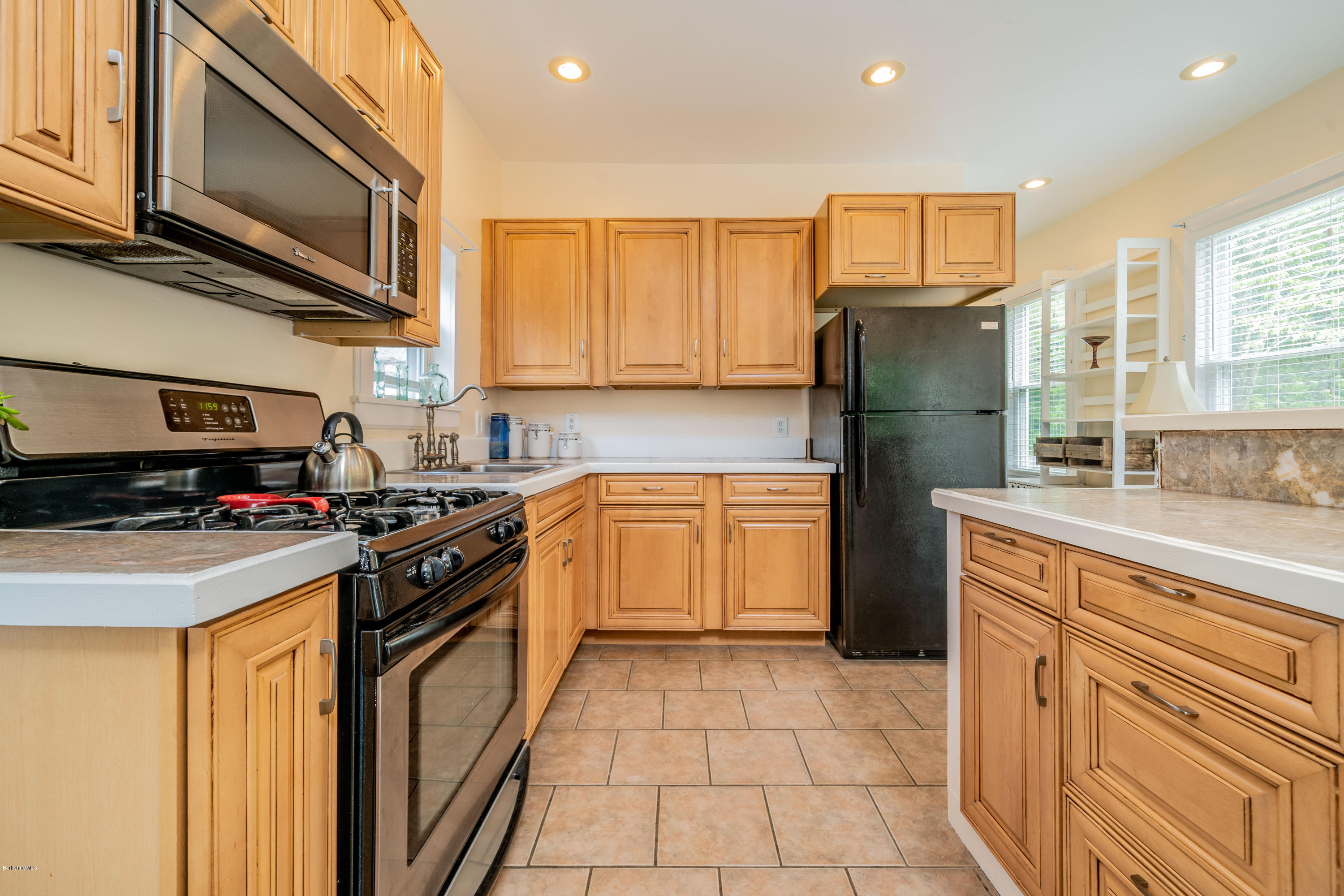 22 Wade Inn Road Becket, MA 01223 - Photo 3 of 32 a kitchen with a stove a sink and a microwave