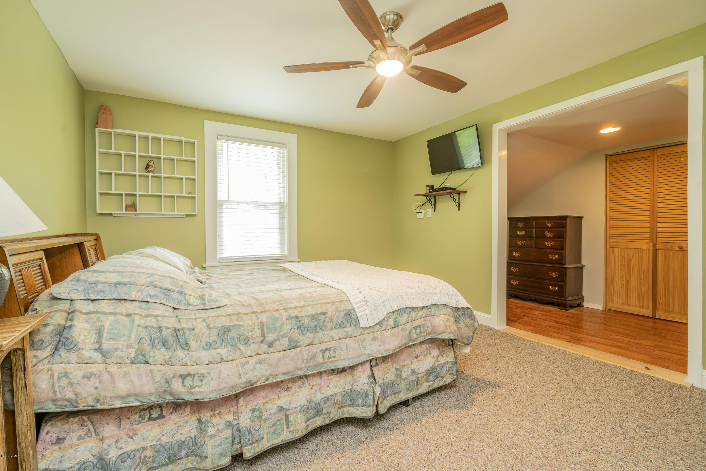 22 Wade Inn Road Becket, MA 01223 - Photo 21 of 32 a bedroom with a bed and a chandelier