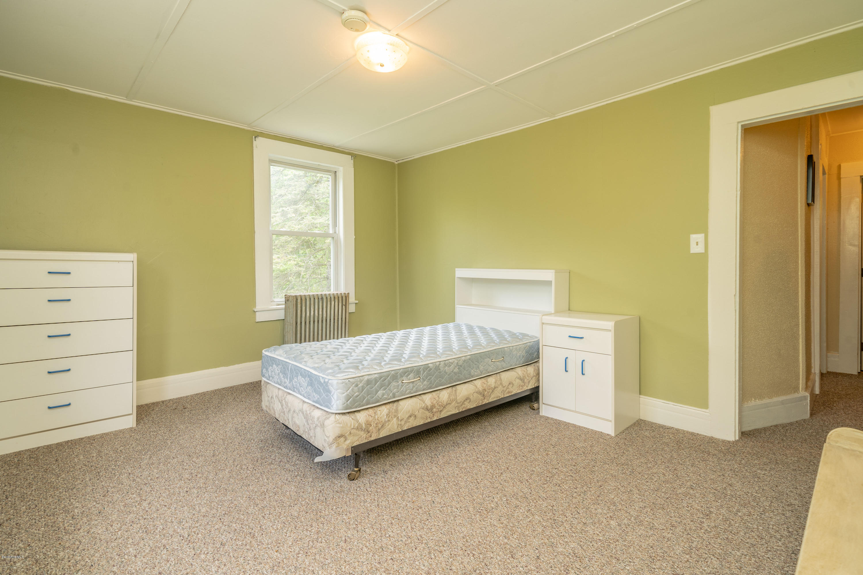 22 Wade Inn Road Becket, MA 01223 - Photo 24 of 32 a spacious bedroom with a bed and a window