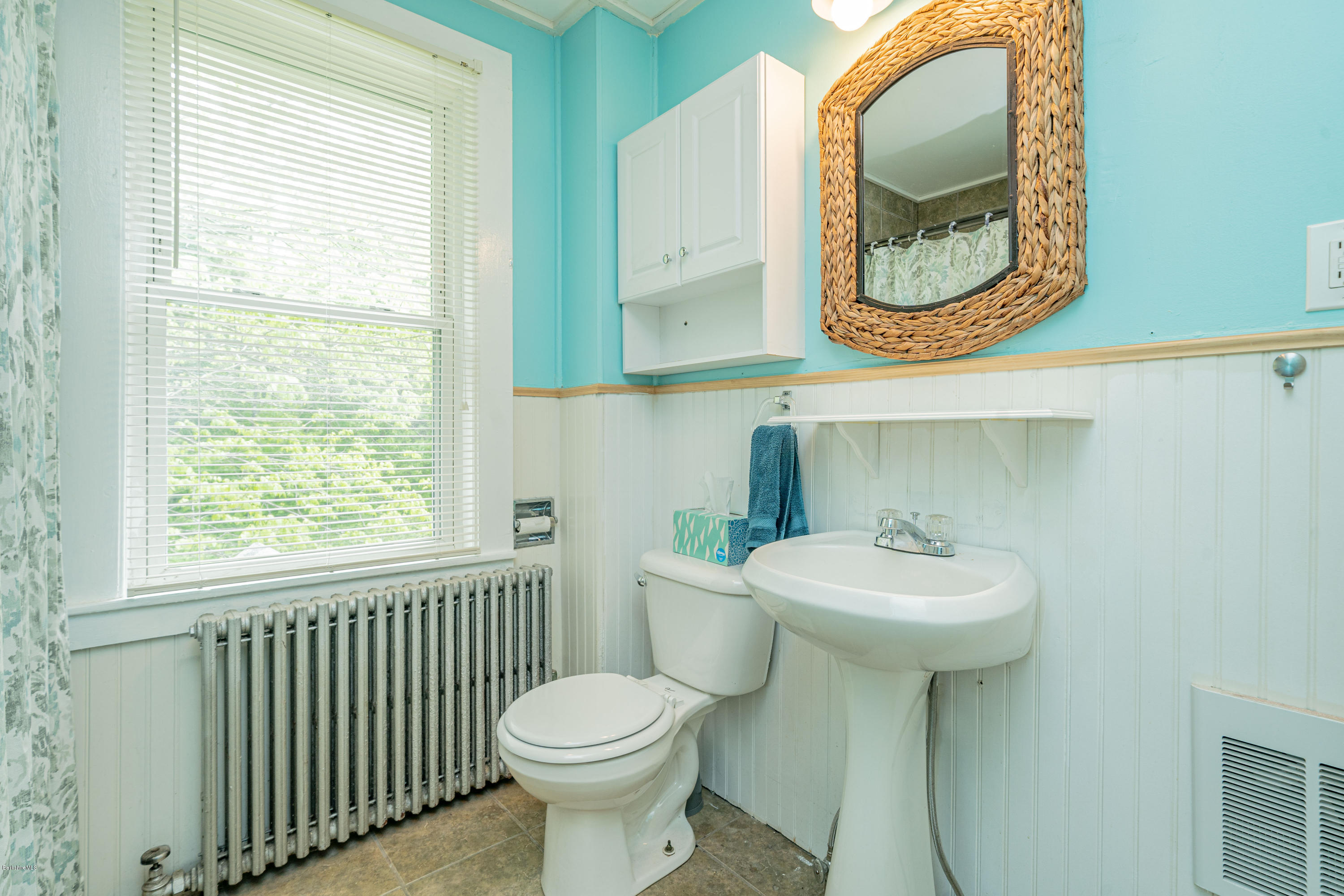 22 Wade Inn Road Becket, MA 01223 - Photo 27 of 32 a bathroom with a sink a toilet and a mirror