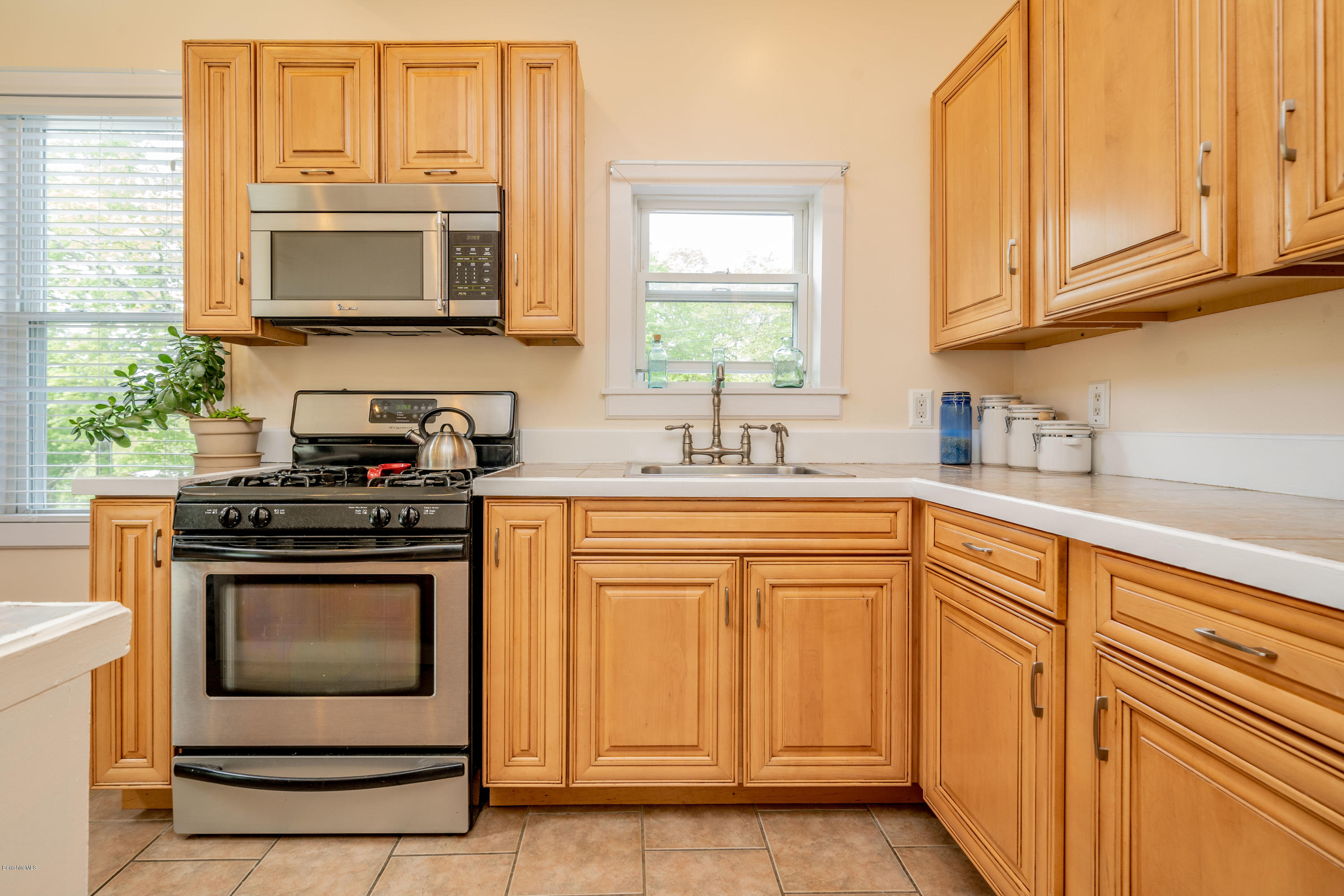 22 Wade Inn Road Becket, MA 01223 - Photo 4 of 32 a kitchen with stainless steel appliances granite countertop a stove a sink and a microwave