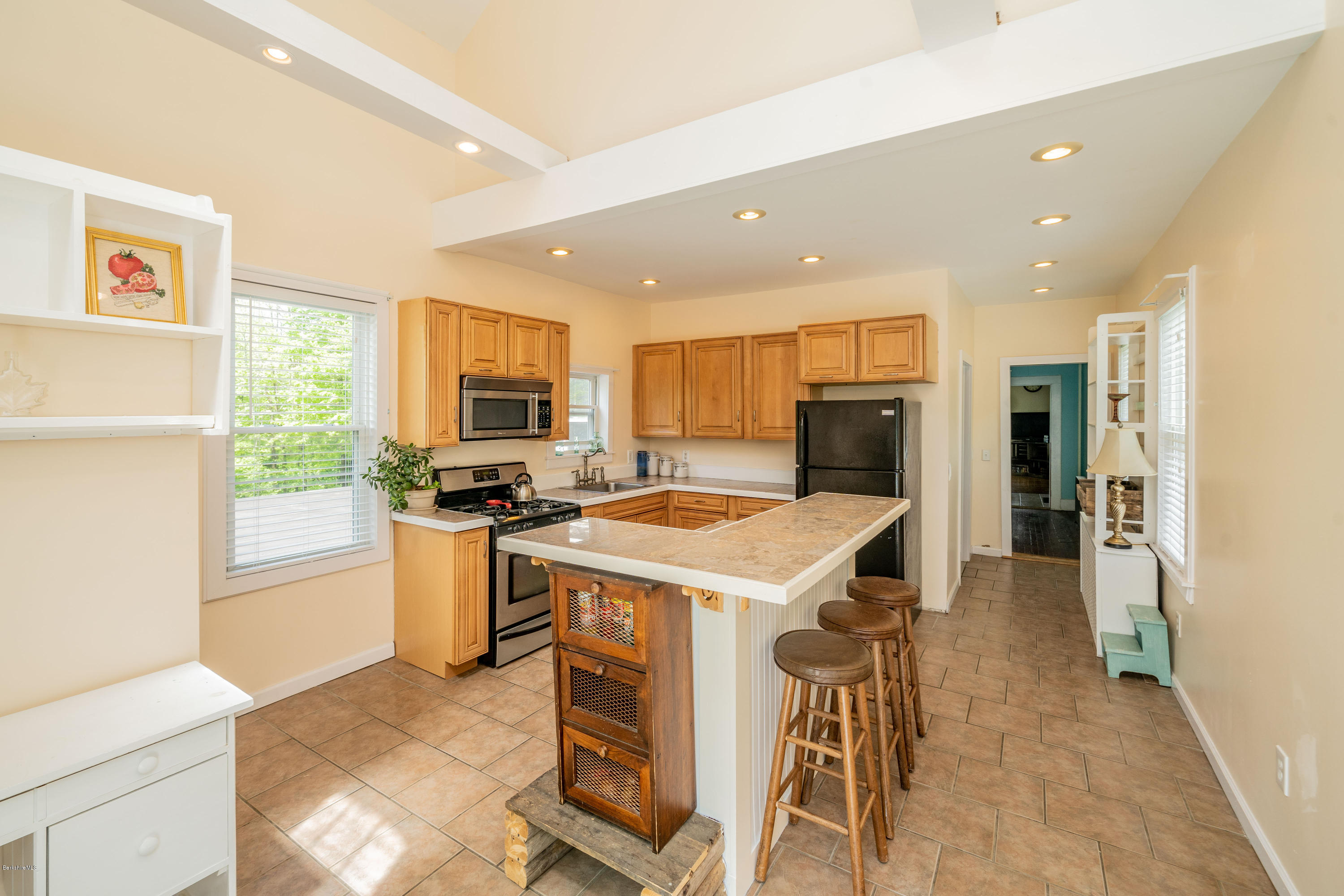 22 Wade Inn Road Becket, MA 01223 - Photo 6 of 32 a kitchen with a stove a refrigerator and a sink