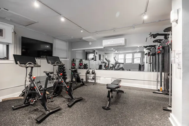 a view of a hallway with a dining table and chairs