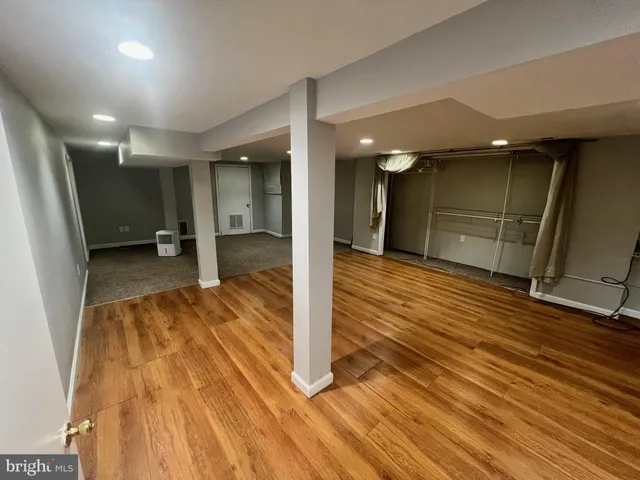 a view of hallway with wooden floor