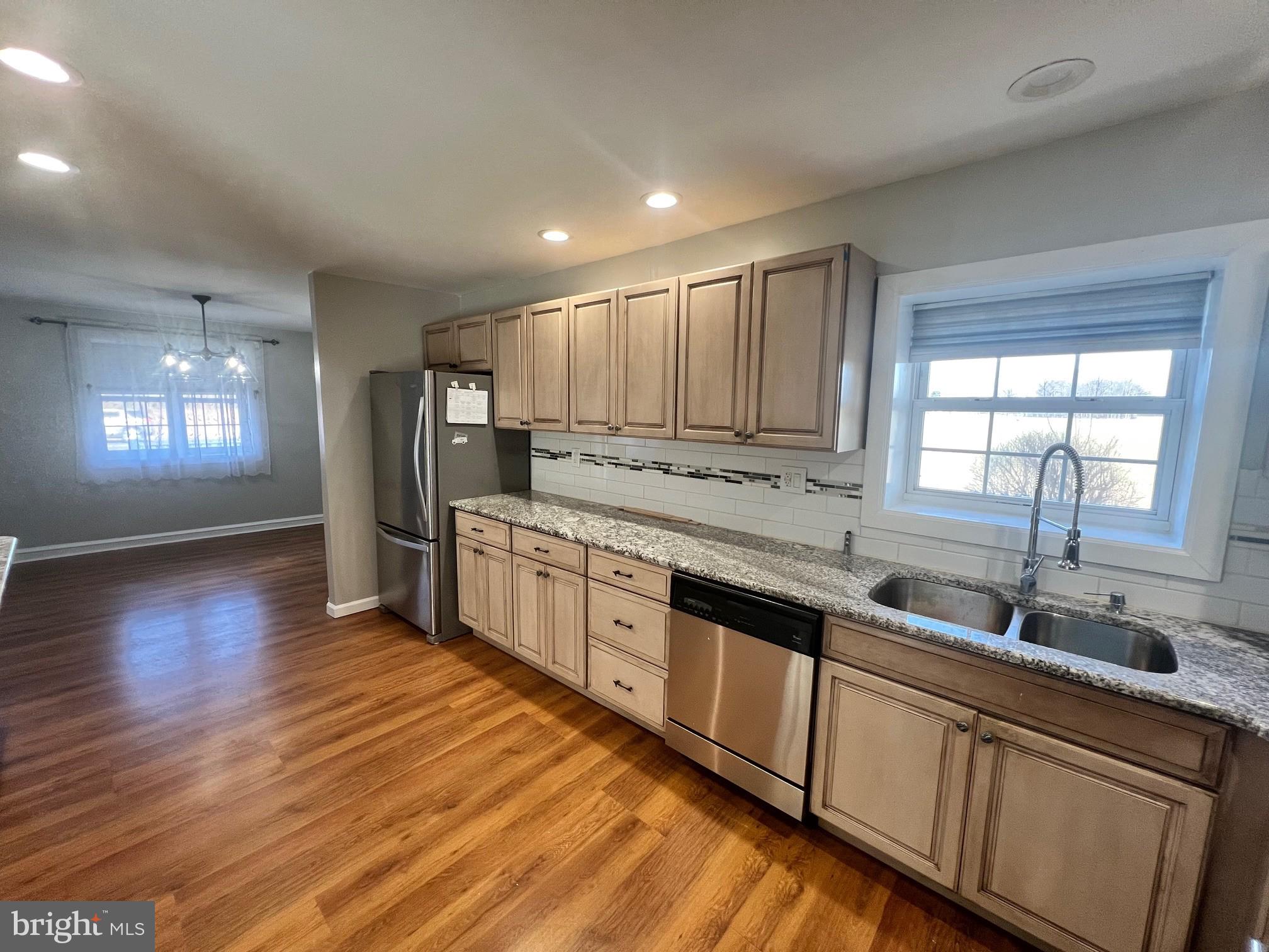 1355 Harding Highway Newfield, NJ 08344 - Photo 7 of 18 a large kitchen with stainless steel appliances granite countertop a sink a stove cabinets and wooden floor