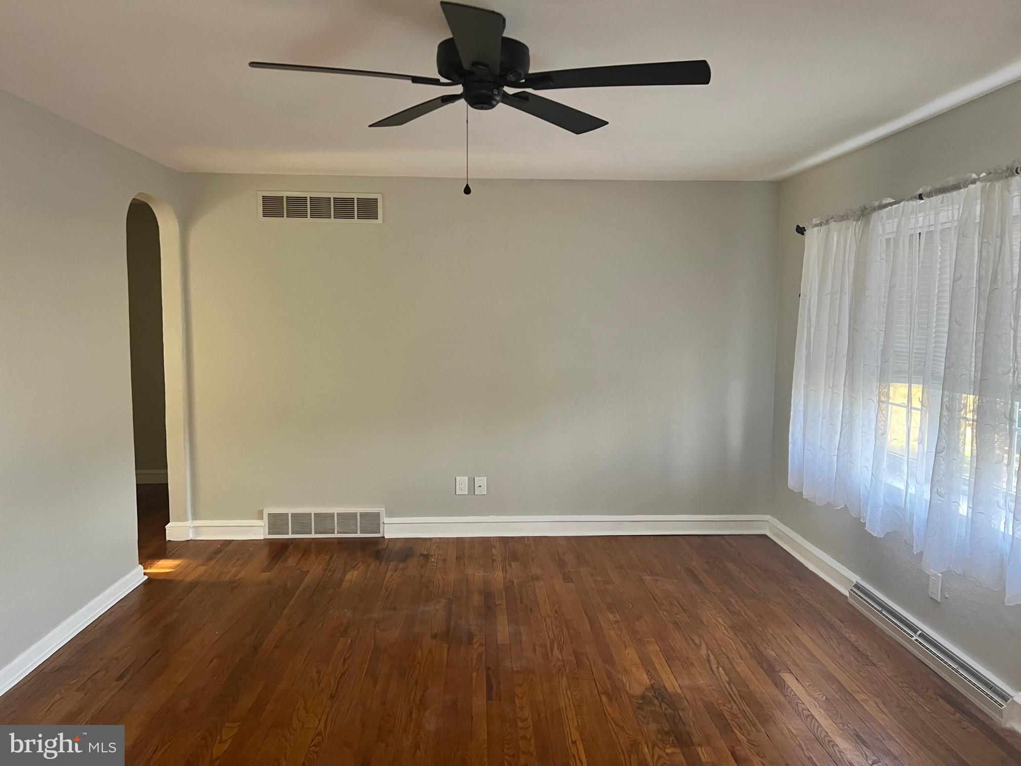 1355 Harding Highway Newfield, NJ 08344 - Photo 10 of 18 wooden floor in an empty room with a window