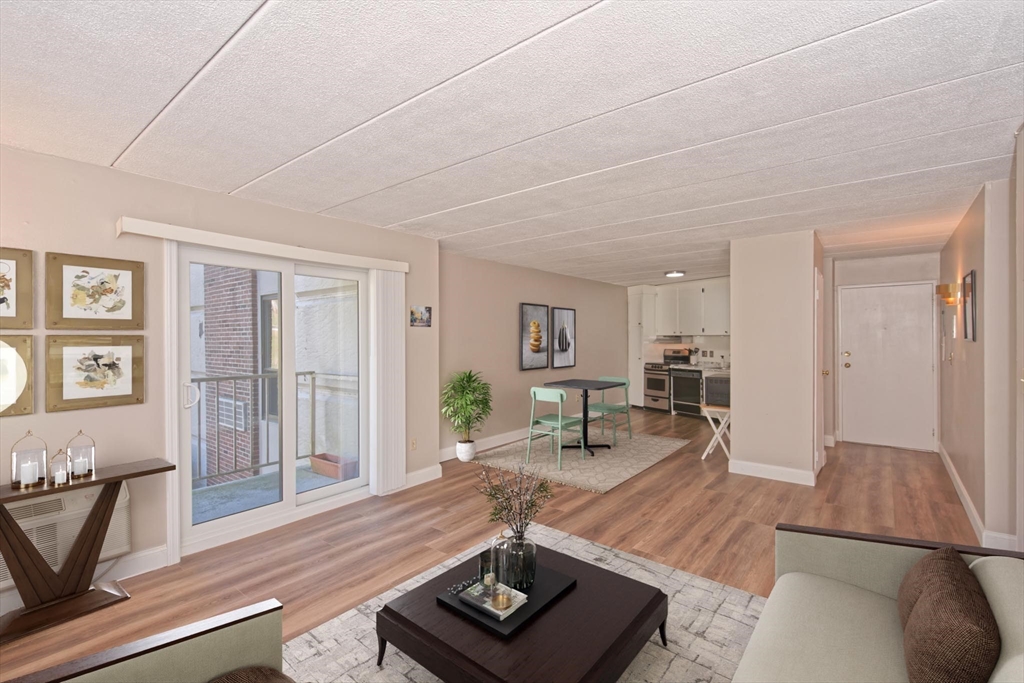 147 Turner Road, Unit 97 Holliston, MA 01746 - Photo 3 of 30 a living room with furniture and a wooden floor