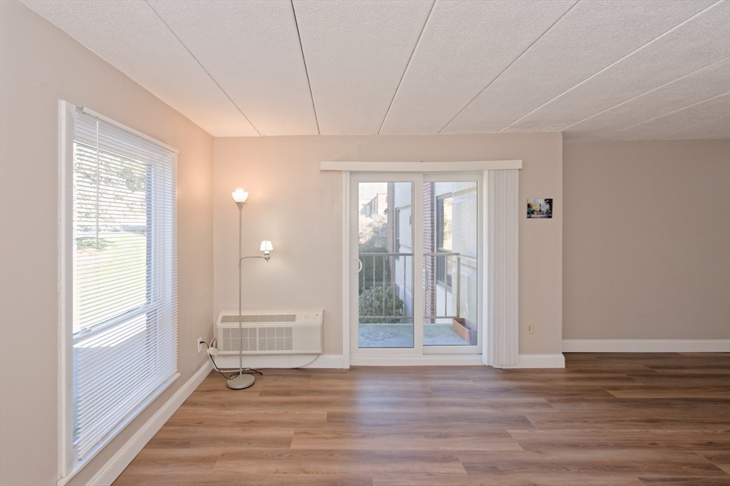 147 Turner Road, Unit 97 Holliston, MA 01746 - Photo 7 of 30 a view of an empty room with wooden floor and a window
