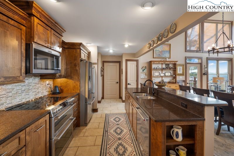 1155 Elk Ridge Road Ferguson, NC 28624 - Photo 13 of 46 a kitchen with stainless steel appliances granite countertop a stove and a refrigerator