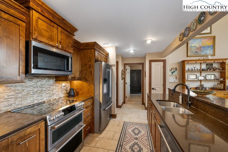 1155 Elk Ridge Road Ferguson, NC 28624 - Photo 15 of 46 a kitchen with stainless steel appliances granite countertop a stove refrigerator and microwave