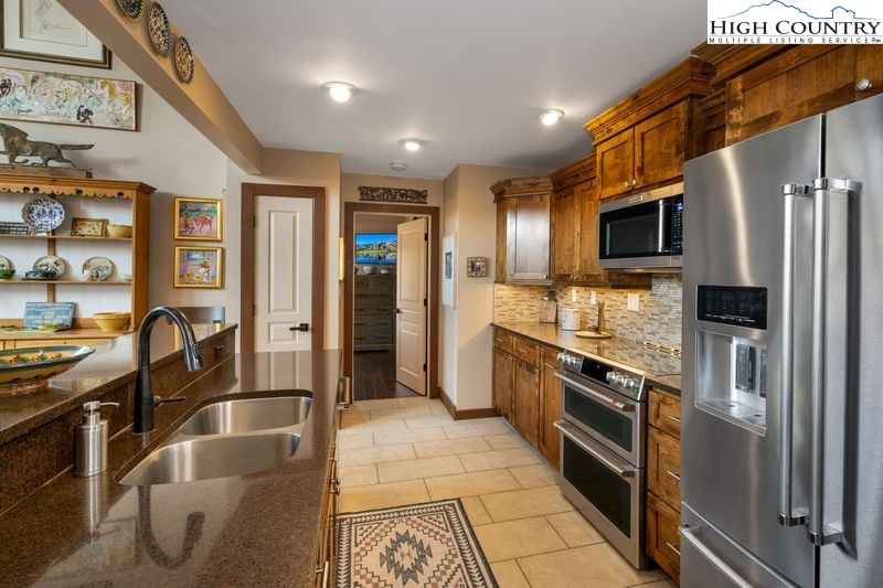 1155 Elk Ridge Road Ferguson, NC 28624 - Photo 21 of 46 a kitchen with stainless steel appliances granite countertop a refrigerator and a stove