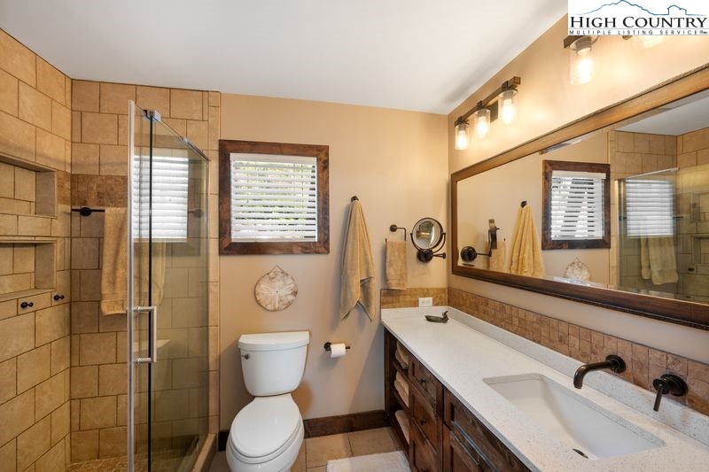 1155 Elk Ridge Road Ferguson, NC 28624 - Photo 23 of 46 a bathroom with a sink a toilet and shower