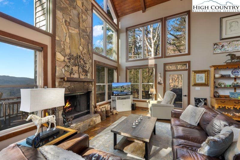 1155 Elk Ridge Road Ferguson, NC 28624 - Photo 4 of 46 a living room with furniture a fireplace and a large window