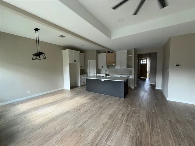 a view of kitchen with sink and refrigerator