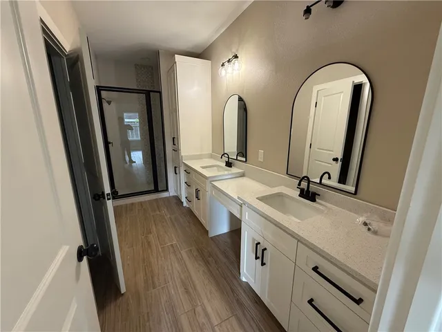 a spacious bathroom with a double vanity sink and a mirror