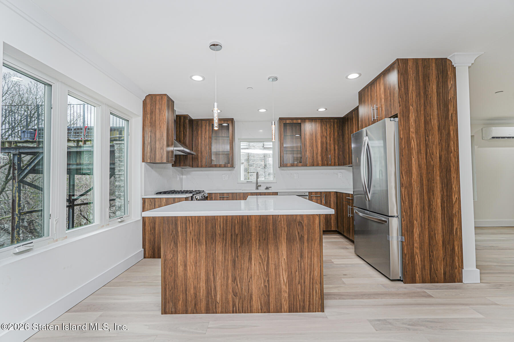 54 Cedarcliff Road Staten Island, NY 10301 - Photo 10 of 49 a kitchen with stainless steel appliances granite countertop a refrigerator a stove and a wooden floors