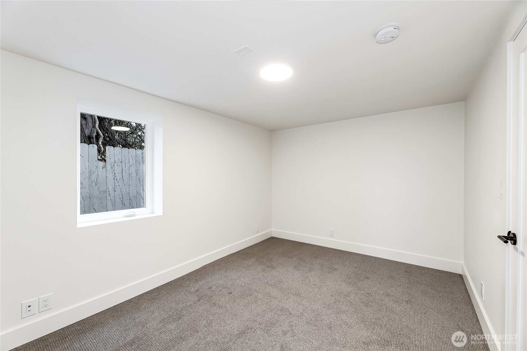 2207 East Republican Street Seattle, WA 98112 - Photo 19 of 24 an empty room with a window