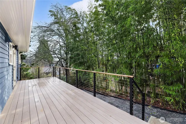 a view of balcony with wooden floor and fence