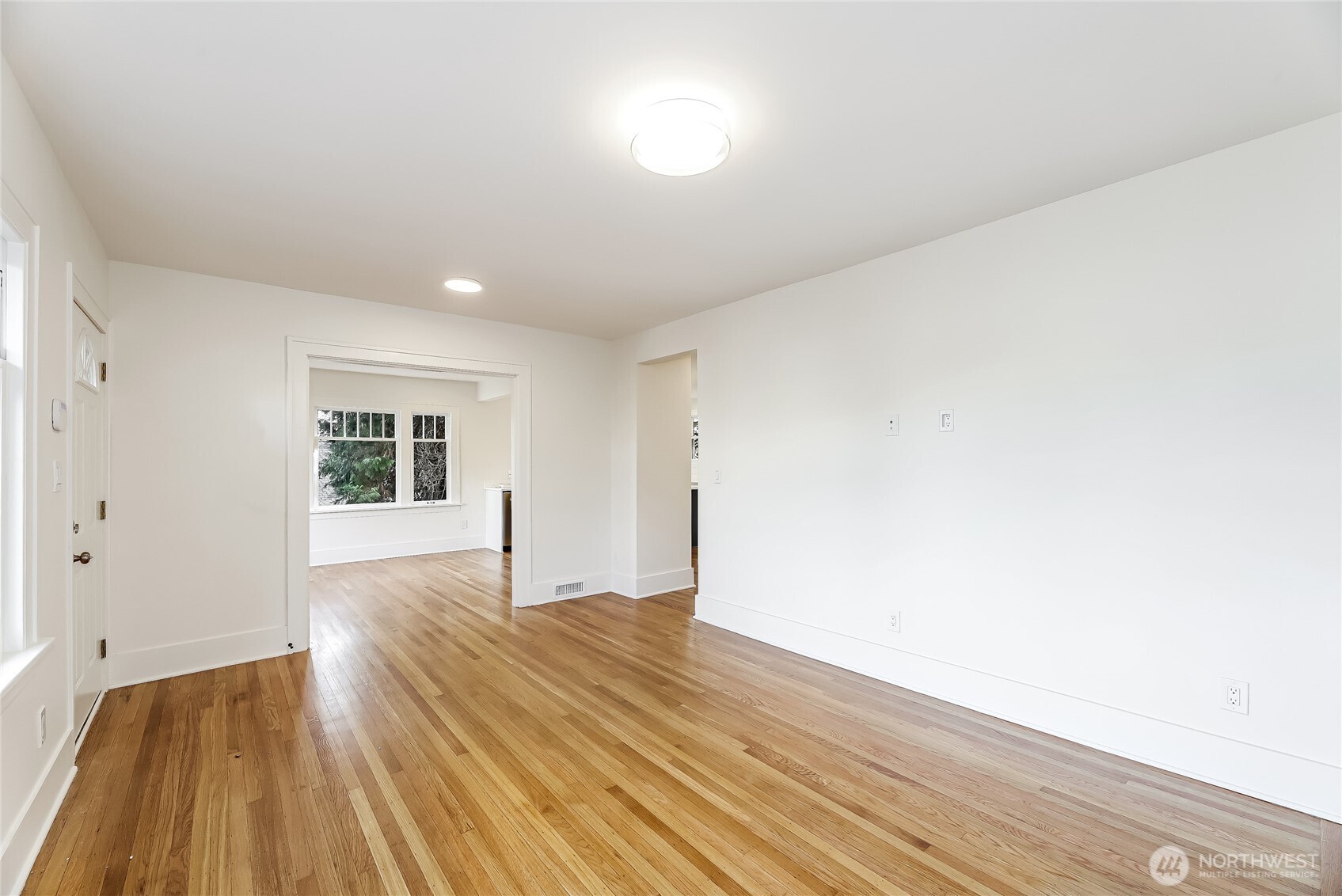 2207 East Republican Street Seattle, WA 98112 - Photo 6 of 24 a view of empty room with wooden floor and fan