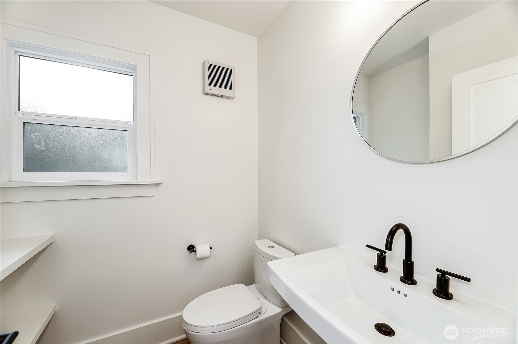 2207 East Republican Street Seattle, WA 98112 - Photo 7 of 24 a bathroom with a sink mirror and toilet