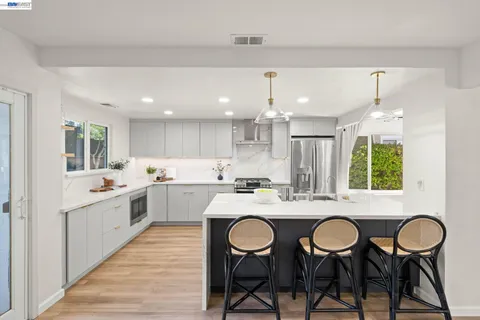 a large kitchen with a table and chairs