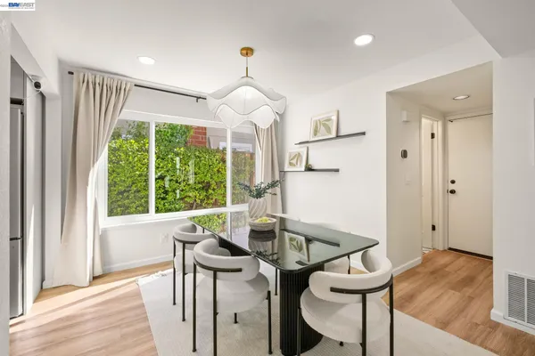 a view of a dining room with furniture window and wooden floor