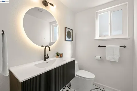 a bathroom with a sink toilet and mirror