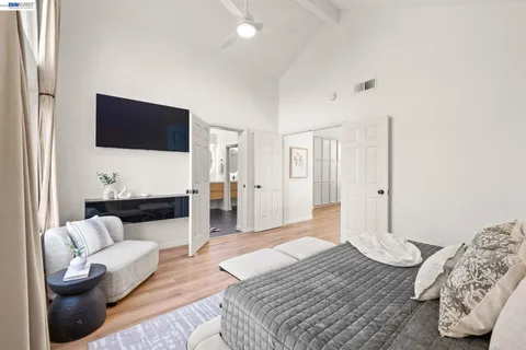 a bedroom with furniture and a flat screen tv