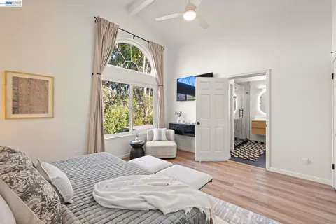 a bedroom with a bed and a couch